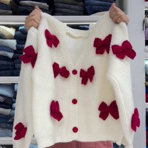 Chic White Knit Cardigan with Bold Red Bow Accents