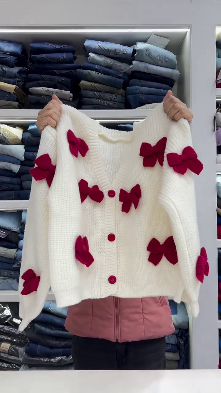 Chic White Knit Cardigan with Bold Red Bow Accents