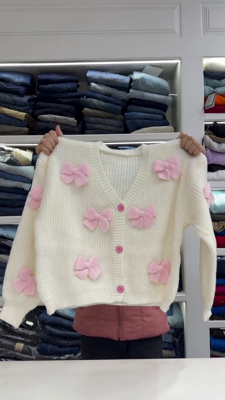Chic White Knit Cardigan with Bold Red Bow Accents - Image 3