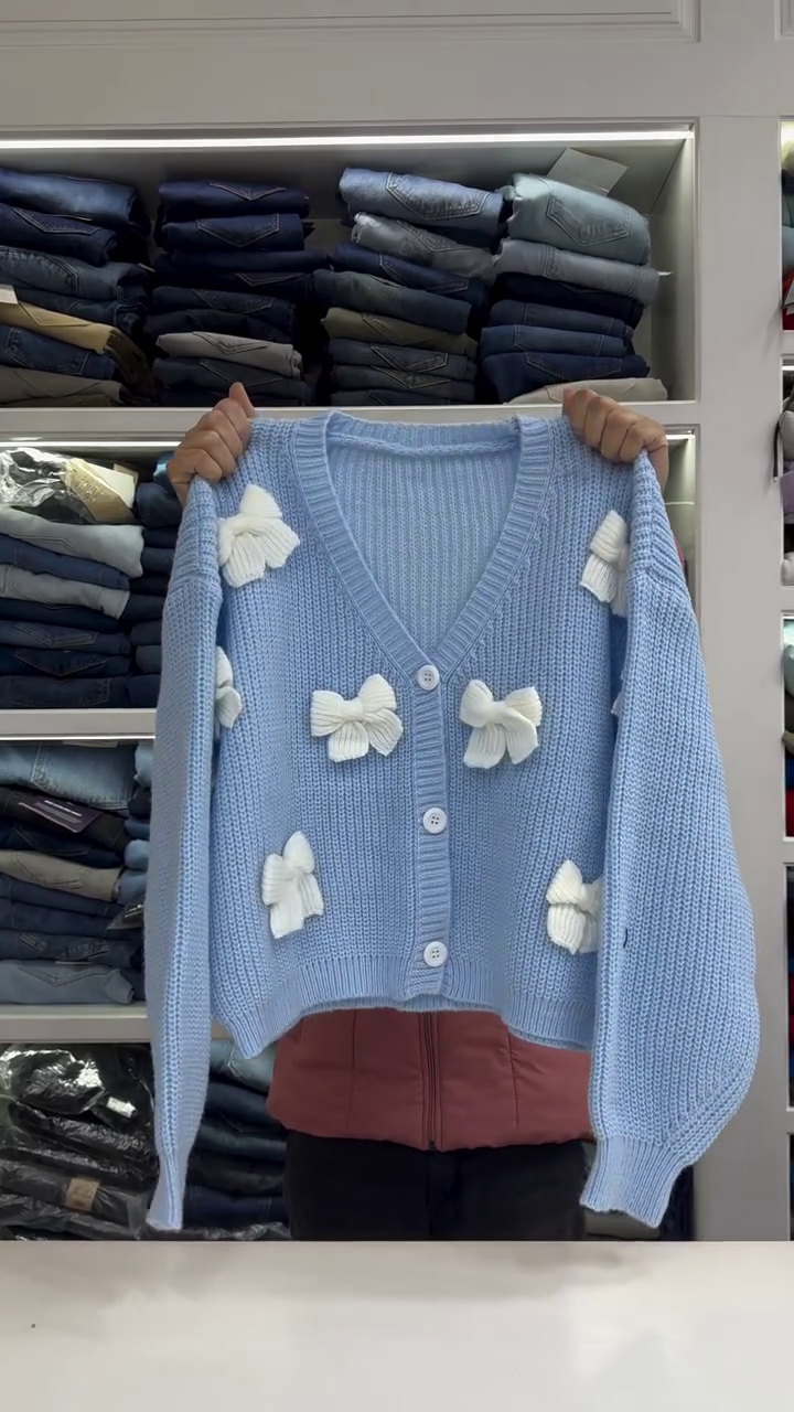 Chic White Knit Cardigan with Bold Red Bow Accents - Image 2